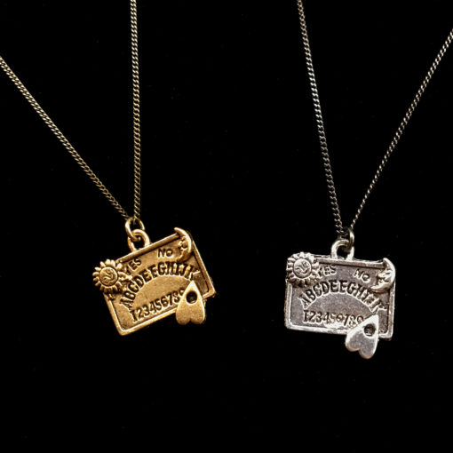ouija board pendant sits on a dainty curb chain