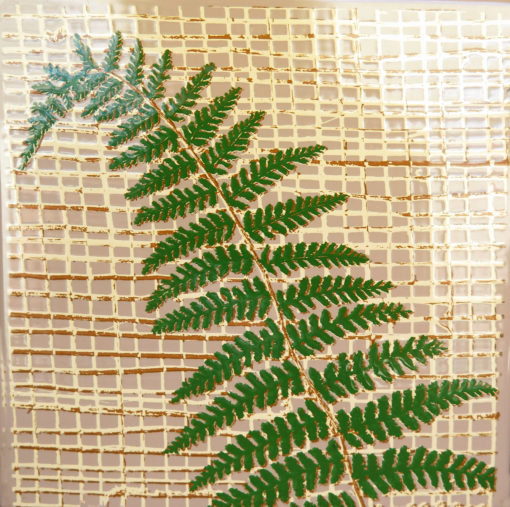 green fern plant on a vintage tile